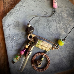 found-bit talisman: &quot;magic words&quot; with crystal, beads, bell, fabric and safety pin