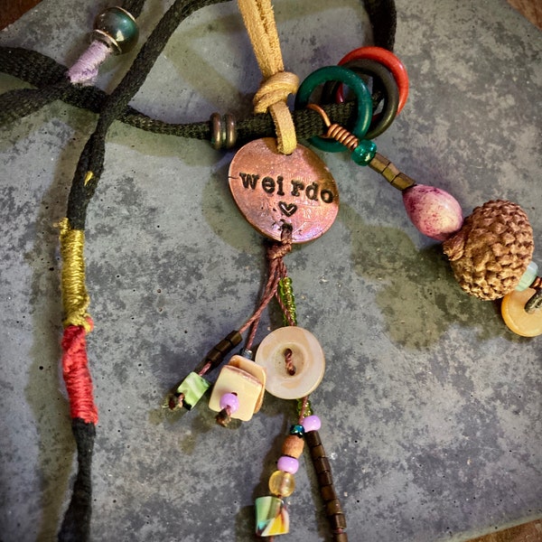 found-bit talisman: "weirdo" stamped penny, buttons, shoelace, acorn, jobs' tear and beads