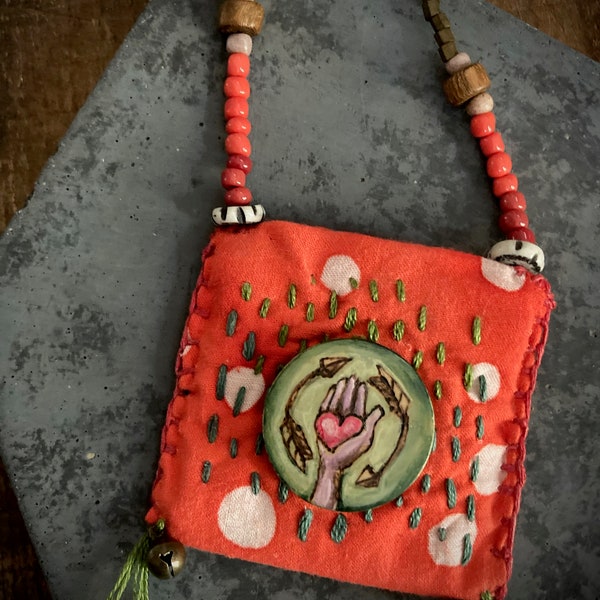 poetry pouch necklace in red with pyrography, bells and beads