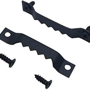 May include: Two black sawtooth picture hangers with screws. The hangers have a series of angled teeth along one edge and a hole for mounting. The screws are black and have a Phillips head.