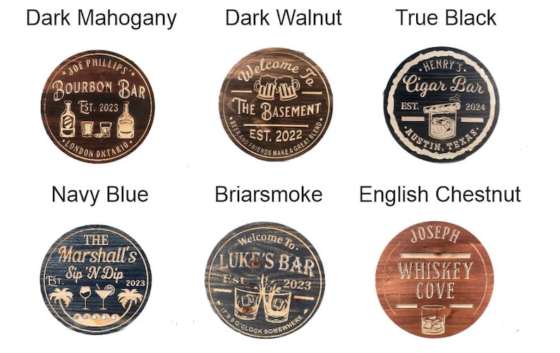 May include: A collection of six wooden bar signs in various colors, including dark mahogany, dark walnut, and navy blue. Each sign features custom text and graphics, such as "Bourbon Bar" and "Cigar Bar."