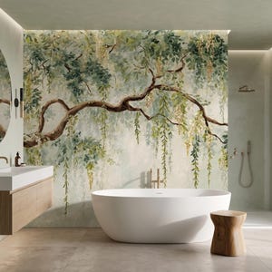 May include: A bathroom featuring a large wall mural of a sprawling tree with hanging green leaves and yellow flowers. The room includes a white oval freestanding bathtub, a wooden vanity with a white sink, a round mirror, and a small wooden stool.