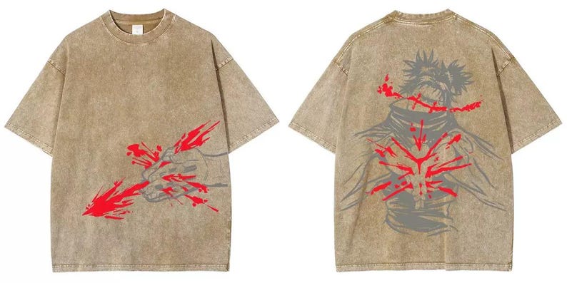 May include: A tan, short-sleeved t-shirt with a graphic design on the front and back. The front features a hand with red splatter, and the back displays a figure with red accents. The shirt has a vintage, washed appearance.