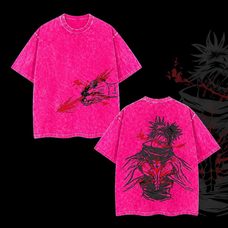 May include: Bright pink t-shirts with a distressed finish. One shirt displays a hand graphic with a red arrow, the other an anime-style character in black and red. The shirts have short sleeves and a crew neck.