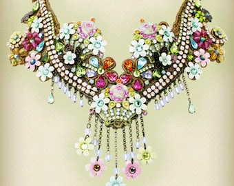May include: A decorative necklace with a floral design, incorporating white, pink, and blue flowers, and embellished with colourful gemstones and hanging chains. The necklace has a gold-toned metal base.