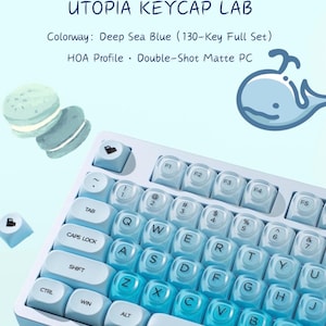 May include: A 130-key full set of Deep Sea Blue keycaps in HOA profile, made of double-shot matte PC. The set features light to dark blue gradient keys, a whale illustration, and macaron graphics. Text reads: UTOPIA KEYCAP LAB, Colorway: Deep Sea Blue (130-Key Full Set), HOA Profile · Double-Shot Matte PC.