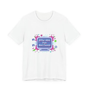 May include: White t-shirt featuring a colorful graphic of a computer monitor with the text "Error 404: Fun Not Found." The design includes pink, blue, green, and purple accents, creating a playful and eye-catching design.
