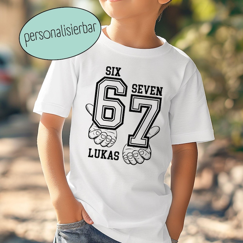 May include: A white short-sleeved t-shirt featuring a black graphic print. The design includes the large numbers 6 and 7, the words SIX, SEVEN, and LUKAS, and illustrations of two hands making gestures beneath the numbers.