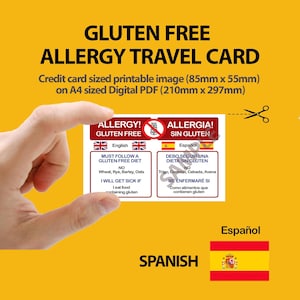 May include: A yellow background with text that reads "GLUTEN FREE ALLERGY TRAVEL CARD". A hand holds a credit card-sized card with English and Spanish text about a gluten-free diet. The card is 8.5cm x 5.5cm.