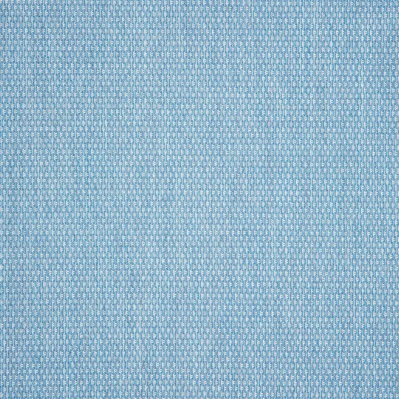 May include: A close-up of a light blue fabric with a woven texture.