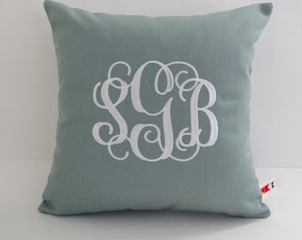 May include: A light blue throw pillow with white embroidered monogram "SCB".