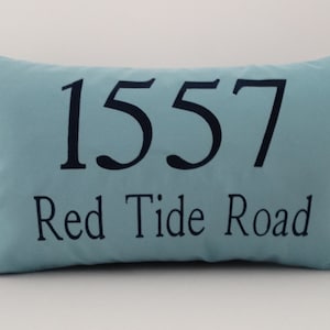May include: A light blue pillow with the address "1557 Red Tide Road" printed in black.
