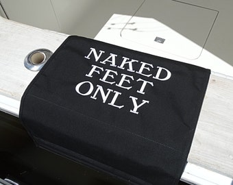 May include: Black mat with white text that reads "NAKED FEET ONLY".
