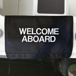 May include: Black boat bumper with white text that reads "WELCOME ABOARD".