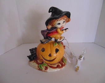 Ceramic Little Girl Flying on illuminated pumpkin with a Cat
