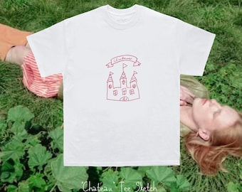 May include: A white short-sleeved t-shirt featuring a red line-art sketch of a castle with a banner above it that reads Chateau. The design is centred on the chest of the garment, which has a crew neckline and a standard fit.