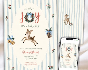 May include: A baby shower invitation and a smartphone displaying the same design. The card features a light blue striped background, a central oval with a fawn, a Christmas wreath, pinecones, and bells. Text reads: oh what joy it's a baby boy! Olivia Anderson, December 12th at 2:00 pm, 1234Anywhere St, Any City ST 12345, RSVP Allison 123.456.7891.