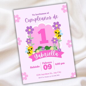 May include: A pink birthday invitation with the text "Te Invitamos al Cumplea&ntilde;os de" and "1". The invitation features purple flowers, yellow bees, and the name "gabriella". The date is February 09.