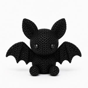 May include: A small, black, three-dimensional bat figurine featuring a distinct, intricate honeycomb-like lattice structure throughout its entire body, including its large pointed ears, outstretched wings, and round eyes.