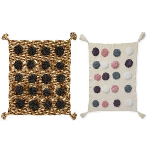 May include: Two decorative throw pillows. One is brown and tan with dark brown pom-poms. The other is off-white with pink, gray, purple, and white pom-poms. Each pillow has tassels at the corners.