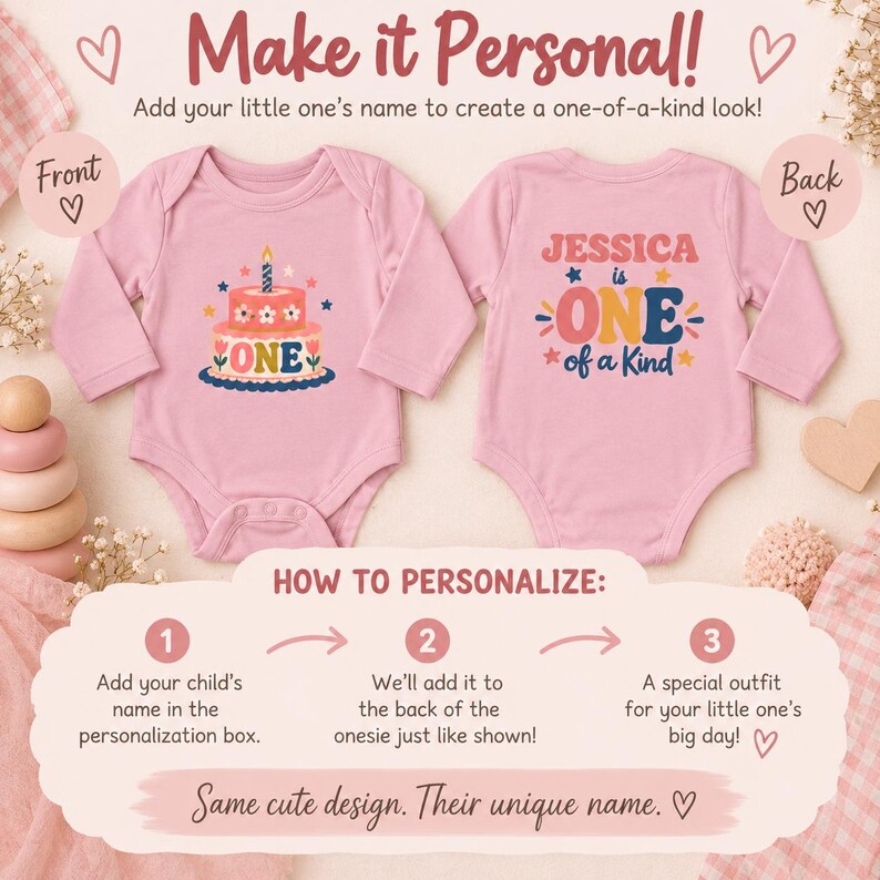 May include: Two light pink long-sleeve baby bodysuits. The front features a two-tier birthday cake graphic with the text ONE. The back displays the text JESSICA is ONE of a Kind with stars and flowers. Text includes Make it Personal and instructions.