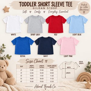 May include: A collection of seven toddler short sleeve t-shirts in white, sport grey, red, light blue, royal blue, navy, and light pink. Includes a size chart with measurements in inches for sizes 2T through 6T and a diagram showing width, length, and sleeve length.