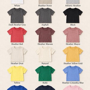 May include: A grid of fifteen short-sleeved toddler t-shirts in various colors labeled Bella+Canvas 3001T. Colors include white, heather stone, athletic heather, dark heather grey, asphalt, black, heather red, maroon, mauve, dust, natural, yellow gold, yellow, kelly, columbia blue, true royal, navy, and pink.