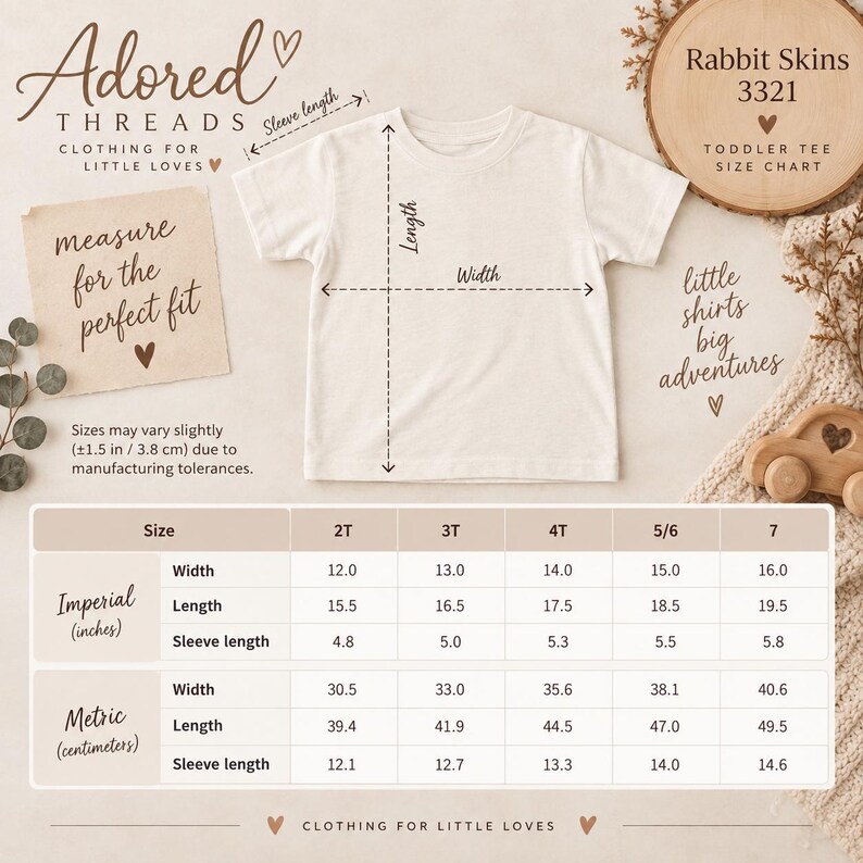 May include: A plain off-white toddler t-shirt displayed with a size chart for Rabbit Skins 3321. The chart provides width, length, and sleeve length measurements in both inches and centimeters for sizes 2T through 7, including a 1.5 inch tolerance note.