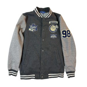 May include: A set of three ceramic mugs with a speckled, matte finish. Each mug features a different color: light blue, cream, and gray. The mugs have a simple, modern design and a comfortable handle.