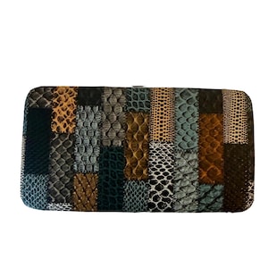 Könnte beinhalten: Rechteckige Clutch mit Patchwork-Design. Die Clutch weist eine Vielzahl von Texturen und Farben auf, darunter Brauntöne, Schwarz, Grau und Blaugrün. Das Design ähnelt einer Collage aus Reptilienhautmustern.