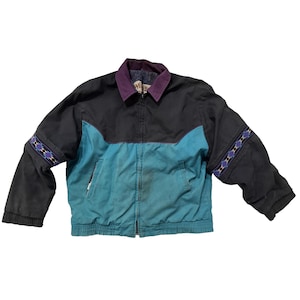 May include: A vintage black and teal jacket with a purple collar and zipper closure. The jacket features a teal front panel, black sleeves, and decorative patterned bands on the upper sleeves. The jacket is a casual outerwear piece.