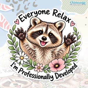 May include: A circular sticker featuring a brown and gray raccoon with raised paws, surrounded by a green leaf wreath and flowers. The text reads Everyone Relax I'm Professionally Developed in black lettering with two small pink hearts.