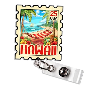 May include: A badge reel featuring a colorful illustration of a Hawaiian beach scene, designed to resemble a postage stamp. The image includes a hammock, palm trees, and the word "HAWAII" in red. The stamp reads "25 USA".
