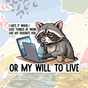 May include: A sticker featuring a cartoon raccoon looking sad at a laptop. Text reads "I hate it when I lose things at work, like my favorite pen. Or my will to live." A coffee cup sits on the desk.