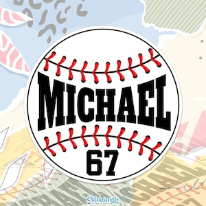 May include: A white baseball-themed sticker with red stitching and the name "MICHAEL" in bold black letters. The number "67" is below the name. The sticker has a circular shape and is designed for sports enthusiasts.