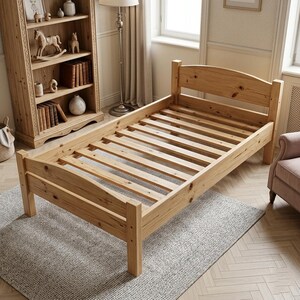 May include: A single bed frame constructed from light-colored natural pine wood, featuring a slatted base, a curved headboard, and a matching curved footboard. The frame has visible wood grain patterns and knots throughout the structure.