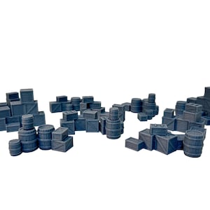 May include: A collection of miniature, dark grey wooden crates and barrels. The crates vary in size and are stacked in small groups. The barrels are also of varying sizes. The objects are arranged on a white background.