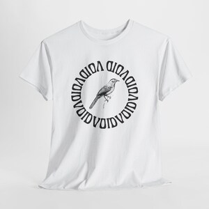 May include: White t-shirt featuring a black and white illustration of a bird perched on a branch, encircled by the word "VOID" in a circular pattern. The shirt has short sleeves and a crew neck.
