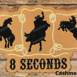 May include: A white ceramic mug with a black handle and the text "But first, coffee" in a black, handwritten-style font. The mug is on a white surface.