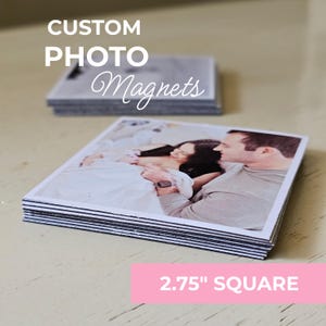 May include: Custom photo magnets stacked on a light surface. The magnets are square, measuring 2.75 inches. The top magnet features a couple in a photo. The text "CUSTOM PHOTO Magnets" is in white.