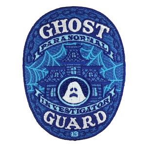 May include: Blue and white embroidered patch with the text "Ghost Guard" and "Paranormal Investigators" around a haunted house with a ghost inside.