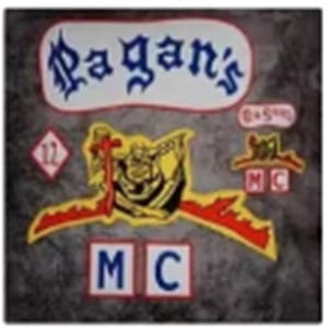 May include: A collection of patches with the text "Pagan's" in a stylized font, along with other patches featuring a skull, a cross, and the letters "MC". The patches are in various colors, including red, yellow, and blue.