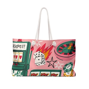 May include: Pink tote bag with a white rope handle featuring a casino-themed design. The design includes a slot machine with the word "JACKPOT!", dice, a roulette wheel, and casino chips. The bag is a large size.