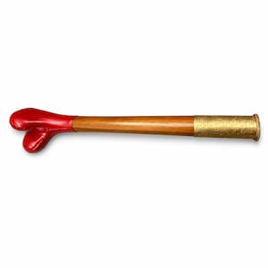 May include: A wooden baton featuring a smooth, glossy red heart-shaped handle at one end and a metallic gold-toned cylindrical cap at the opposite end. The gold cap is decorated with an intricate, embossed pattern along its entire surface.