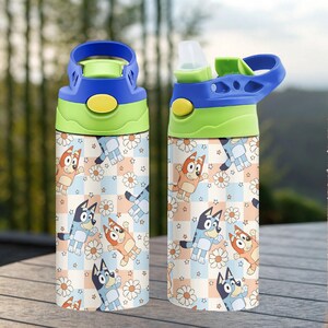 May include: Two water bottles with blue, green, and yellow lids. The bottles feature a repeating pattern of cartoon dogs, daisies, and stars on a checkered background. One bottle's lid is open.