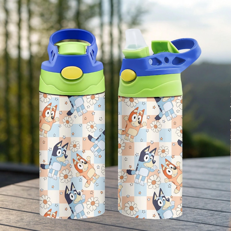 May include: Two water bottles with blue, green, and yellow lids. The bottles feature a repeating pattern of cartoon dogs, daisies, and stars on a checkered background. One bottle's lid is open.