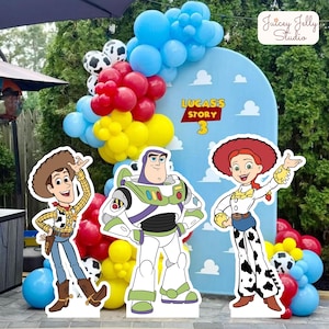 May include: A party scene featuring cutouts of Woody, Buzz Lightyear, and Jessie from Toy Story. A blue backdrop with the text "Lucas's Story 3" is decorated with balloons in blue, red, yellow, and black and white.