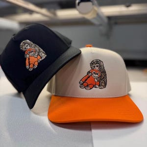 May include: A rustic wooden sign with the text "Welcome to our home" in white lettering. The sign features a distressed finish and a simple, inviting design, perfect for front door decor.