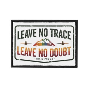 May include: Rectangular patch with a black border and the words "LEAVE NO TRACE" and "LEAVE NO DOUBT" in a distressed font. The design includes a rainbow-colored mountain range, two pine trees, and the text "TRAIL PROUD."
