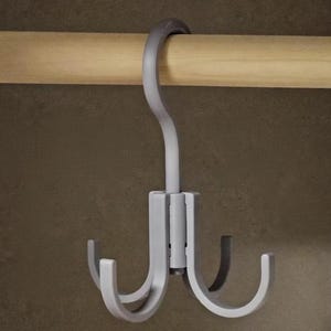 May include: A gray multi-hook hanger with four curved hooks. The hanger is designed to hang on a wooden rod, with a curved top for easy placement. The hooks are evenly spaced and suitable for organizing items.